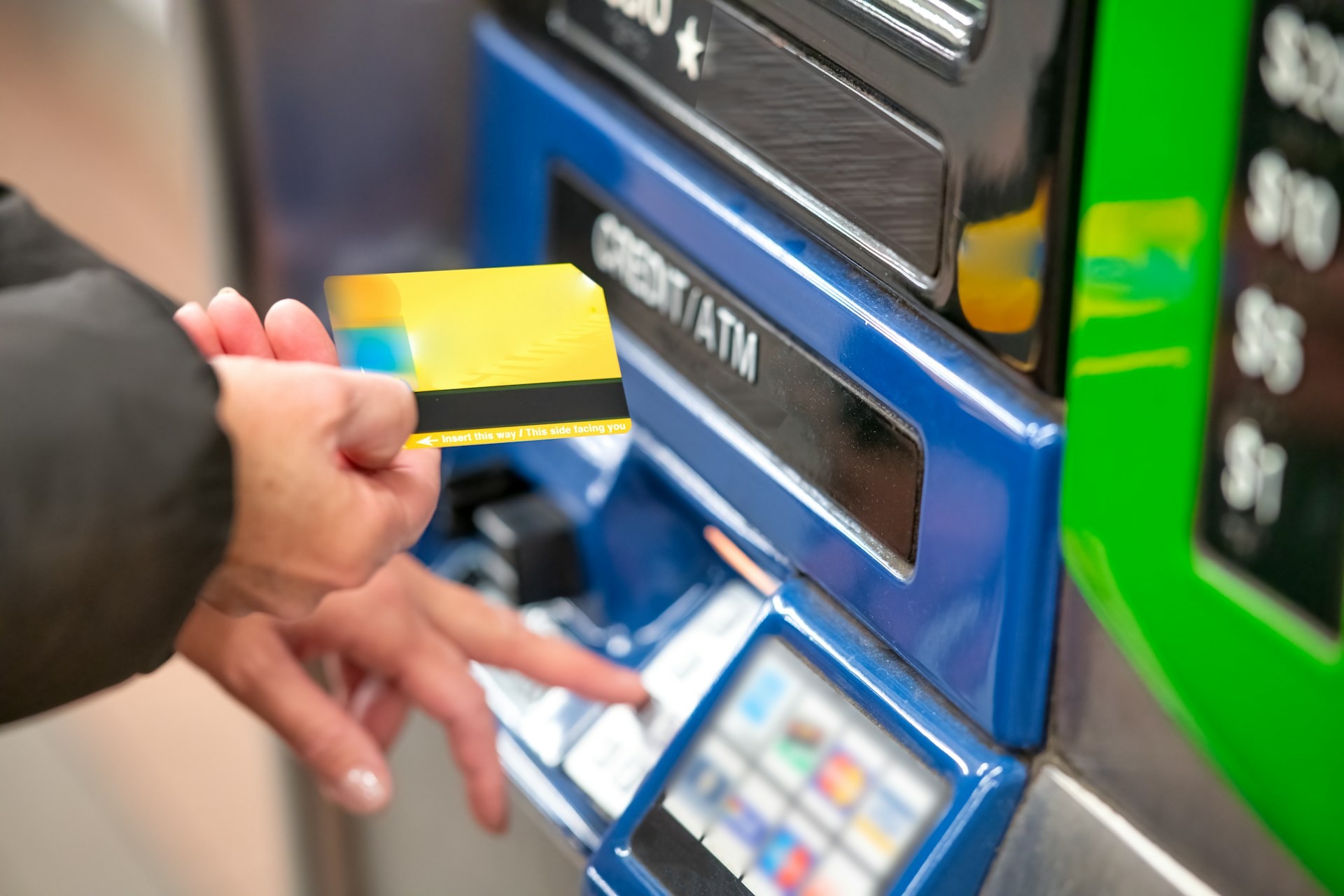 A person using a card at an ATM-style machine — convenient access to cash after check cashing.